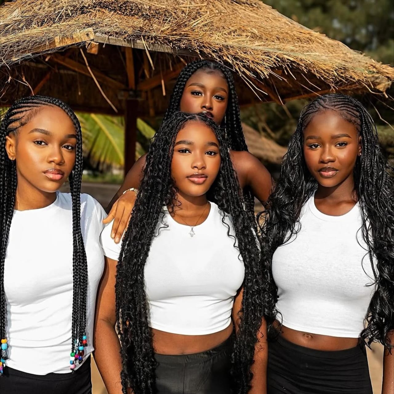 Four women showcasing beautiful African braids by Antwerpen Braiders